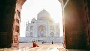 Woman sitting in front of the Taj Mahal in Agra, India