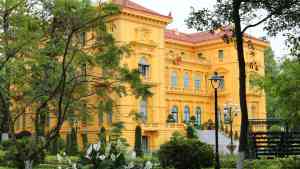 Bright yellow Presidential Palace in Hanoi on a Vietnam tour