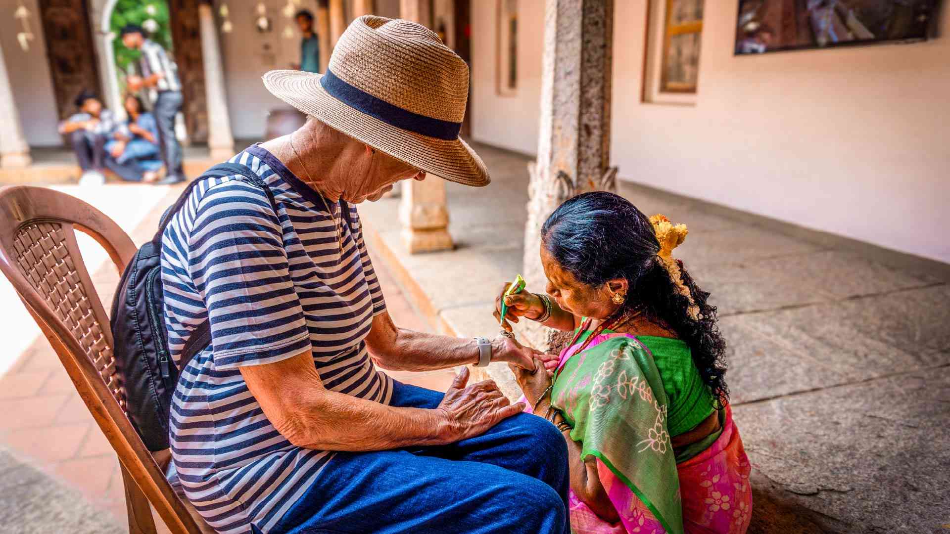 A local woman practising henna on a traveller in Chennai, India