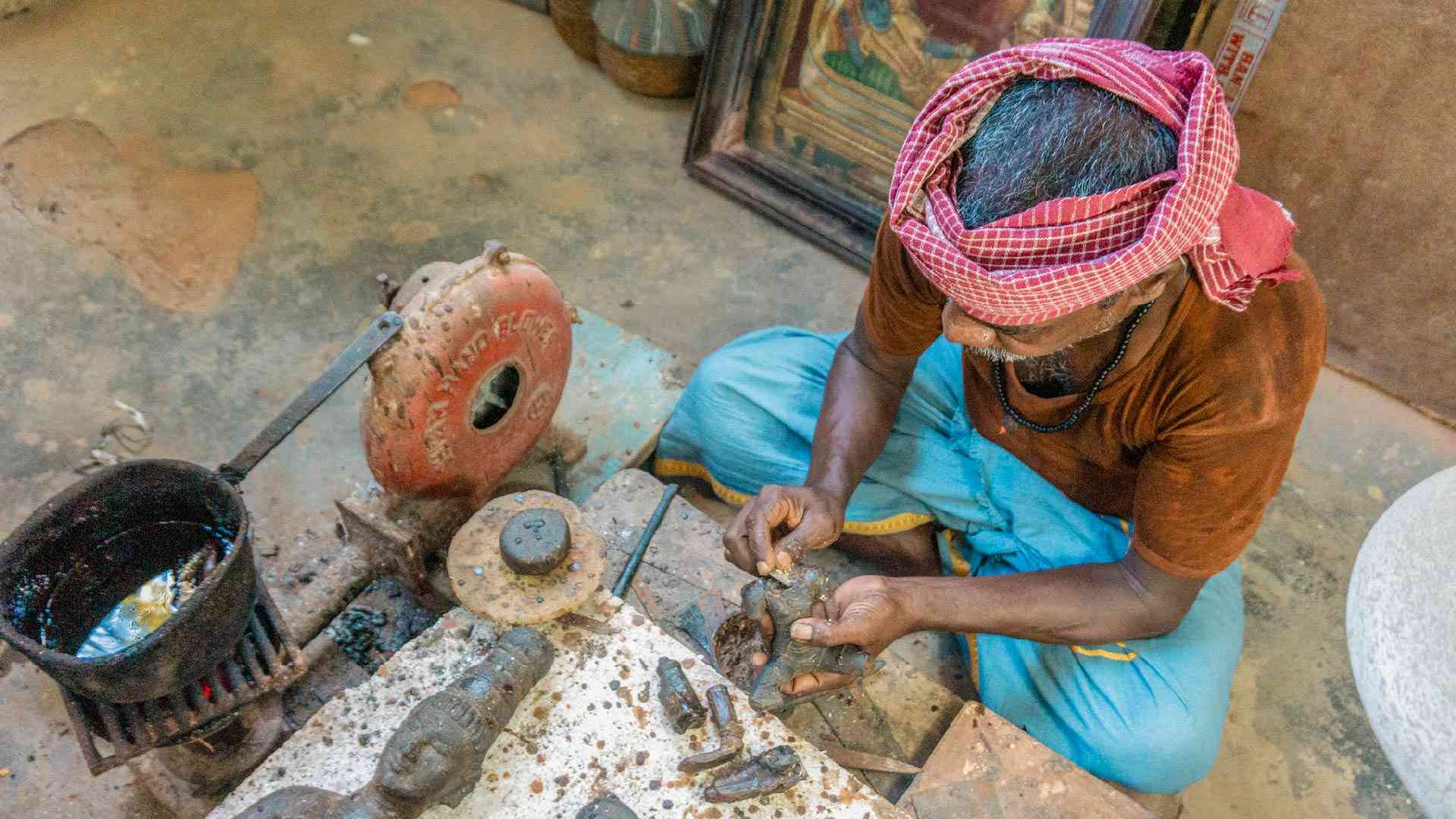 A local crafting an object in a bronze factory in Thanjavur, India