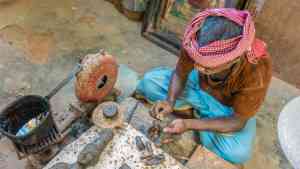 A local crafting an object in a bronze factory in Thanjavur, India