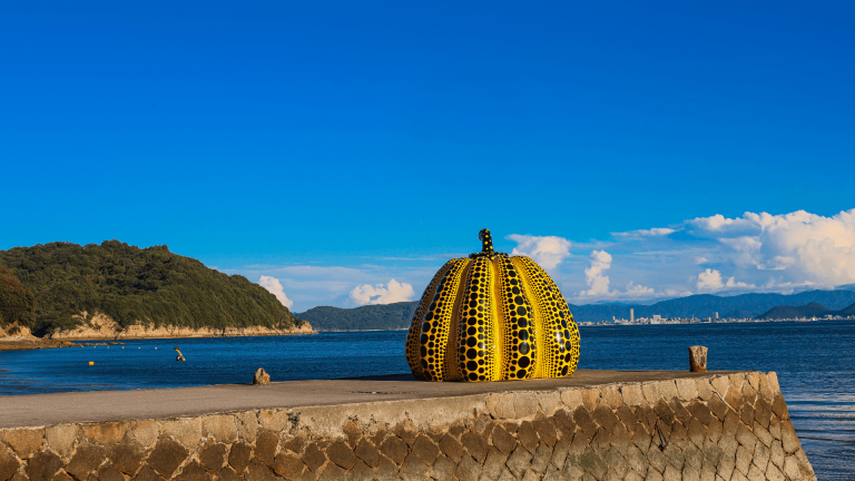 Yellow Pumpkin sculpture by artist Yayoi Kusama on the pier at Naoshima Art Island, Japan by Jeremy van Heerde