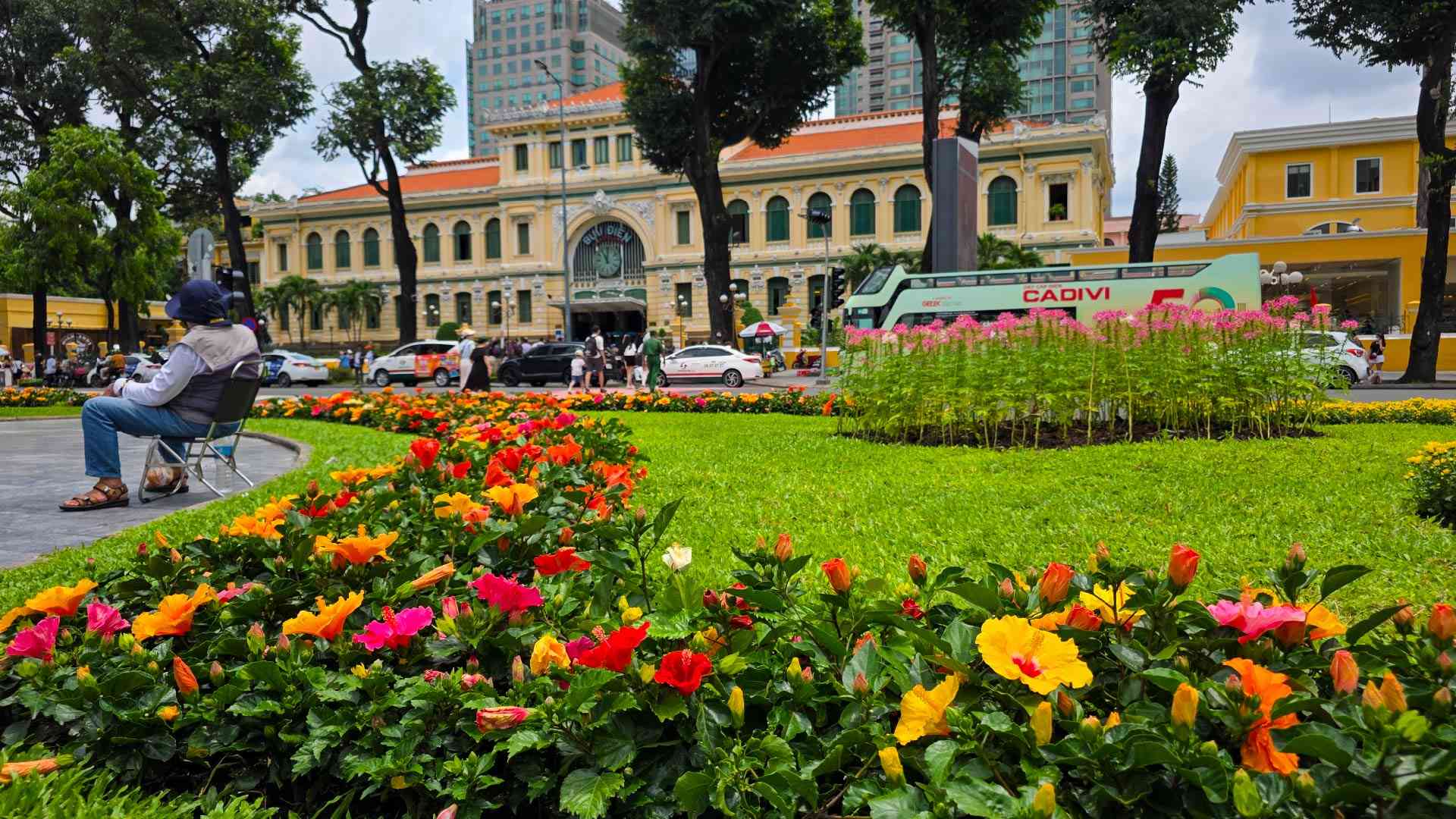 Bright flowers in front of the Saigon Central Post Office in Vietnam on a Bunnik Tour