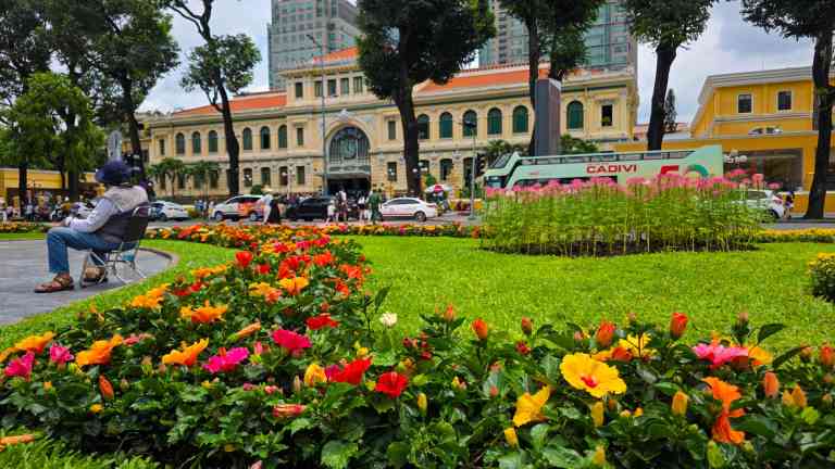 Bright flowers in front of the Saigon Central Post Office in Vietnam on a Bunnik Tour