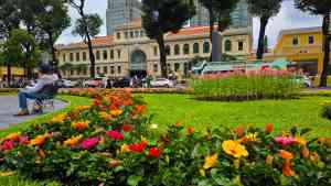 Bright flowers in front of the Saigon Central Post Office in Vietnam on a Bunnik Tour