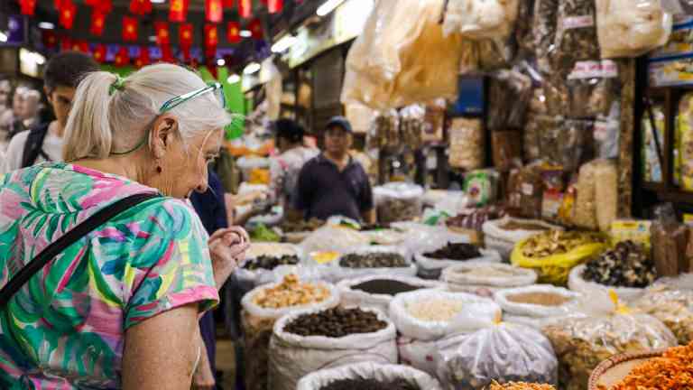 A woman looking at spices in Hanoi, Vietnam on a Bunnik Tour