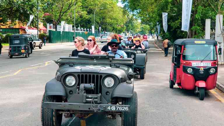 People in an open-top Jeep driving around Colombo, Sri Lanka on a Bunnik Tour