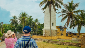 Two travellers standing outside Galle lighthouse in Sri Lanka on a Bunnik Tour