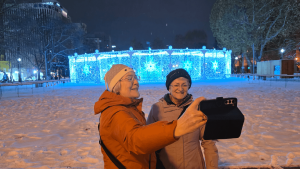 Travellers laughing in front of Winter decorations in Sapporo, Japan by Dennis Bunnik