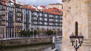 Buildings lining a river in Bilbao, Spain