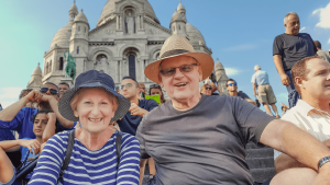 A couple sitting in Paris on a Bunnik Tour of France