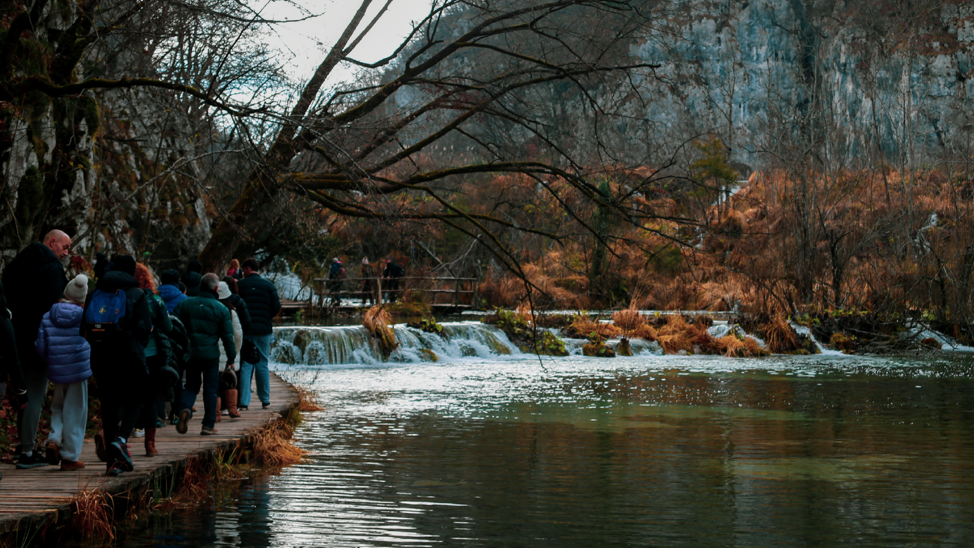 Travellers walking along the boardwalks at Plitvice Lakes National Park, Croatia by Hera Sparnon
