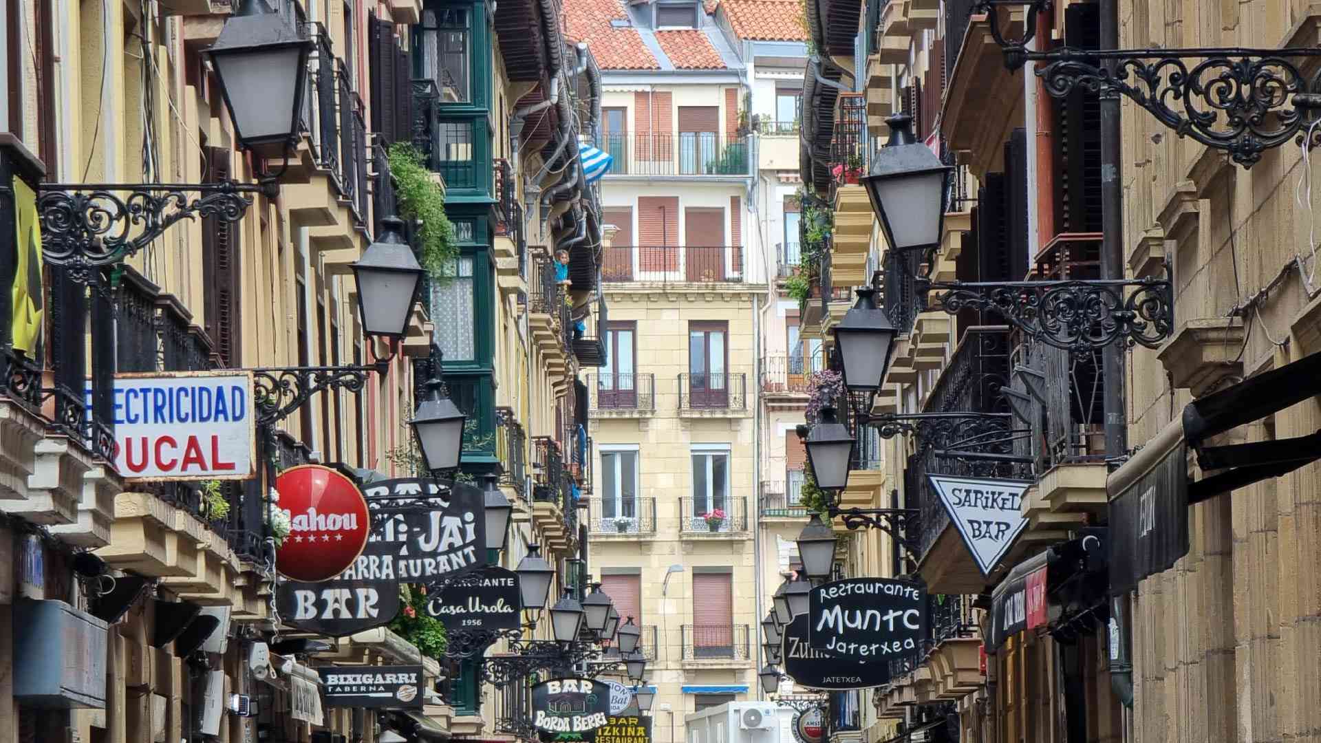 Buildings on narrow street in San Sebastian, Spain by Dennis Bunnik