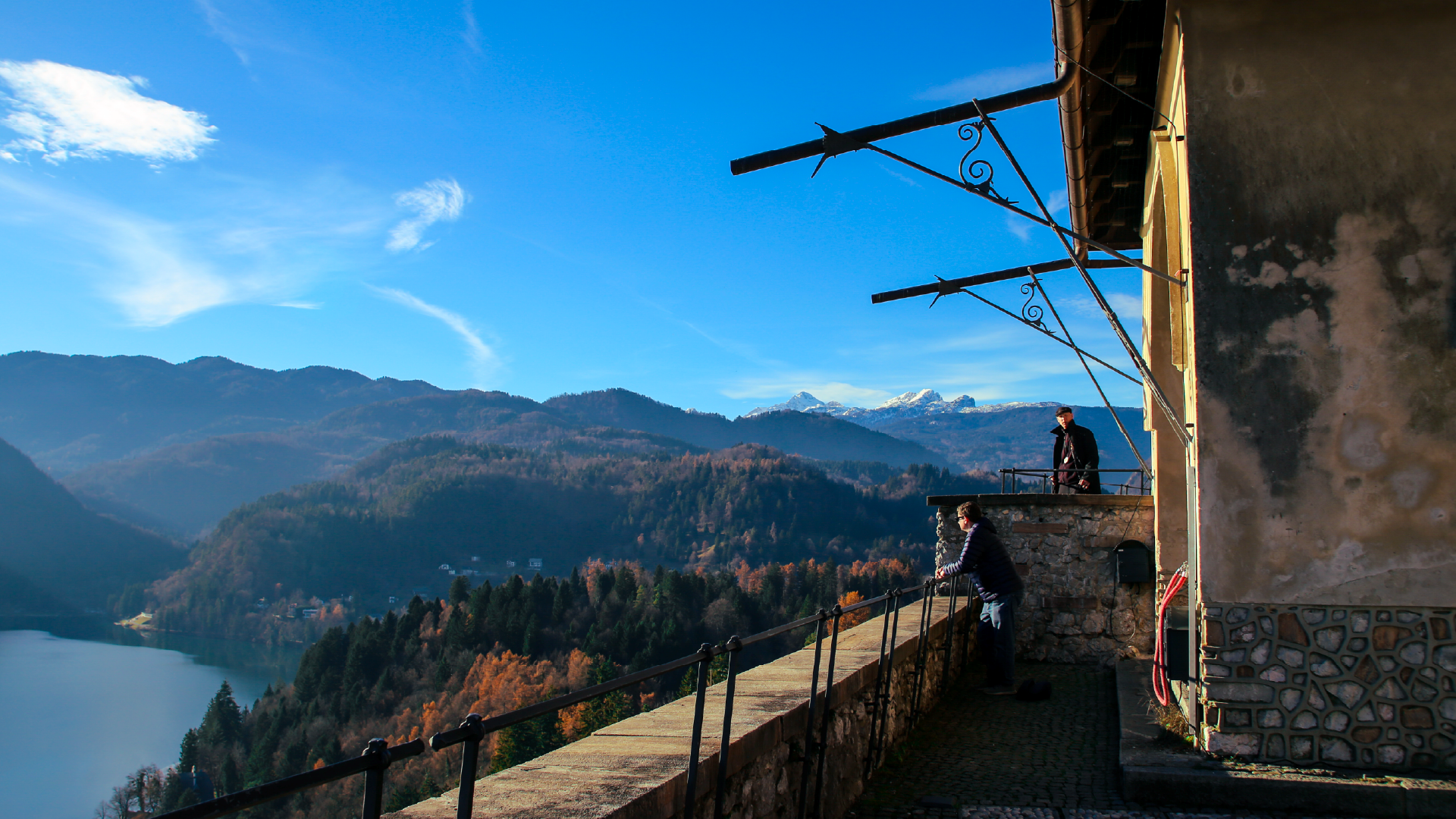 People looking out over Lake Bled, Slovenia by Hera Sparnon
