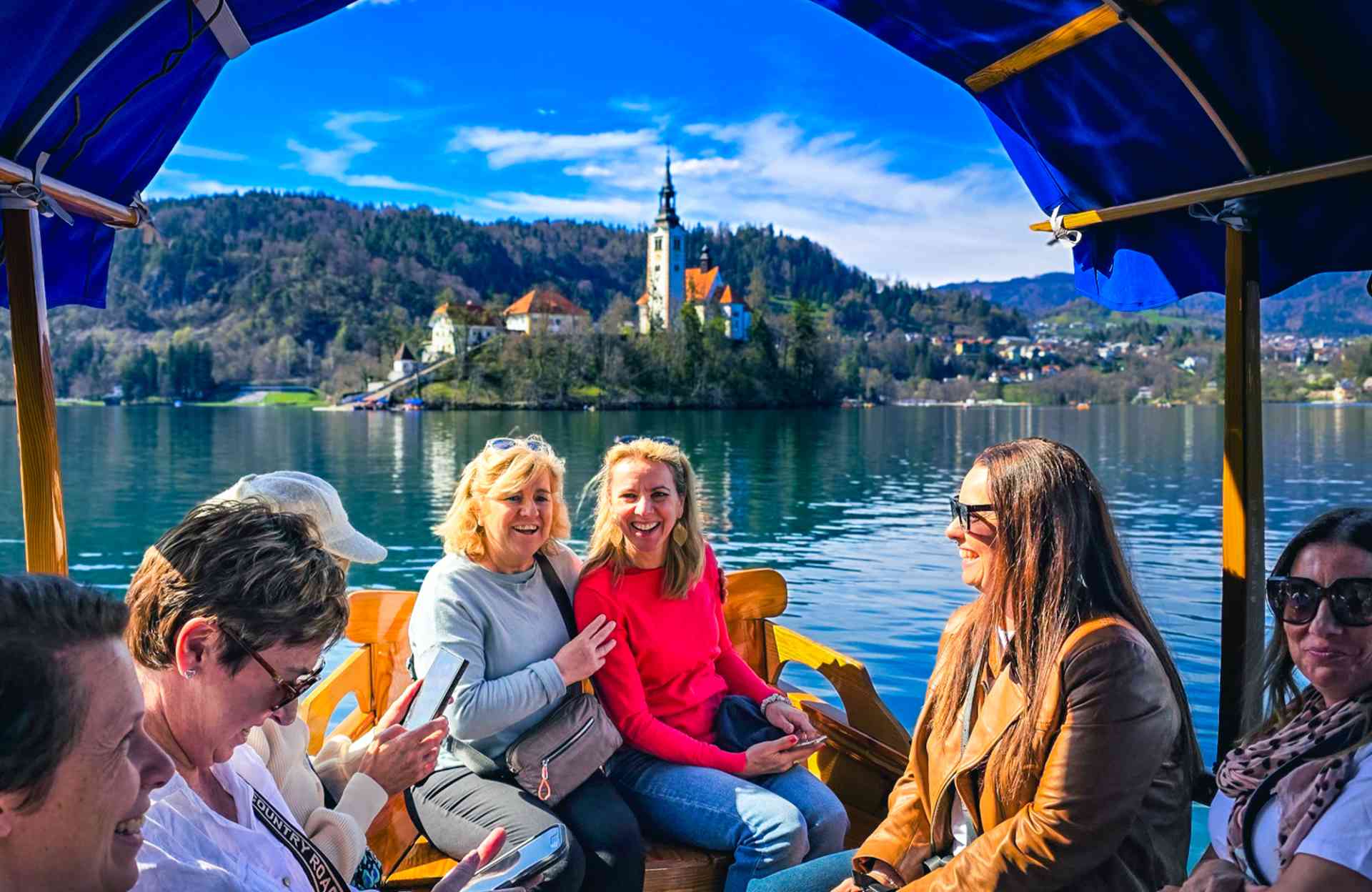 Travellers sitting in a boat in Lake Bled, Slovenia