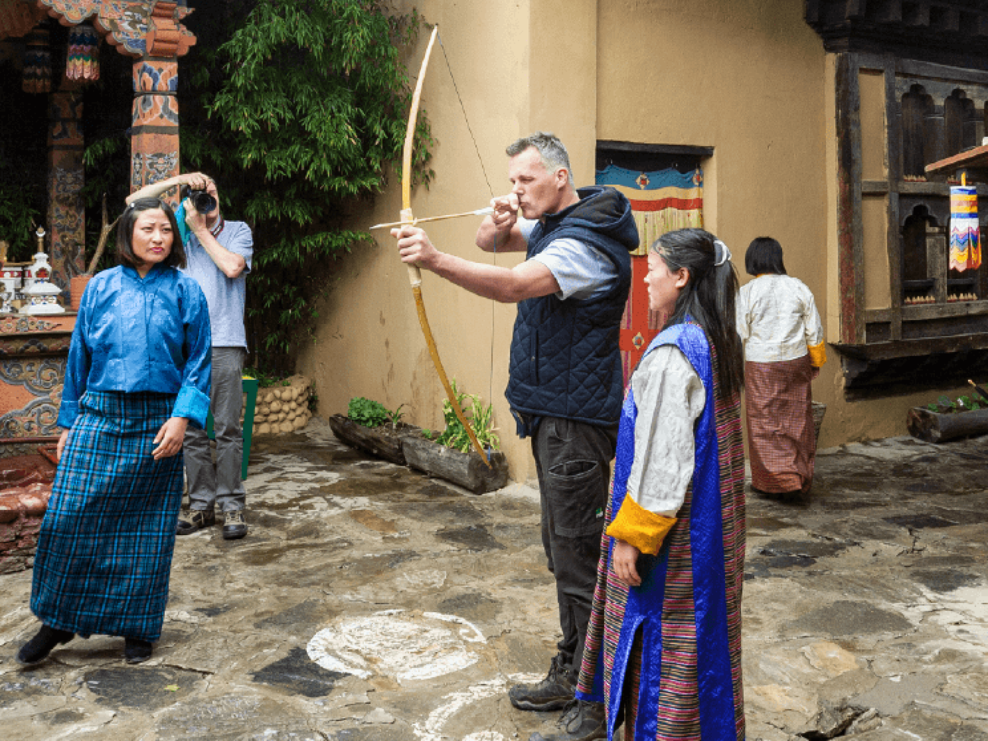 Traveller trying their hand at traditional archery in Bhutan