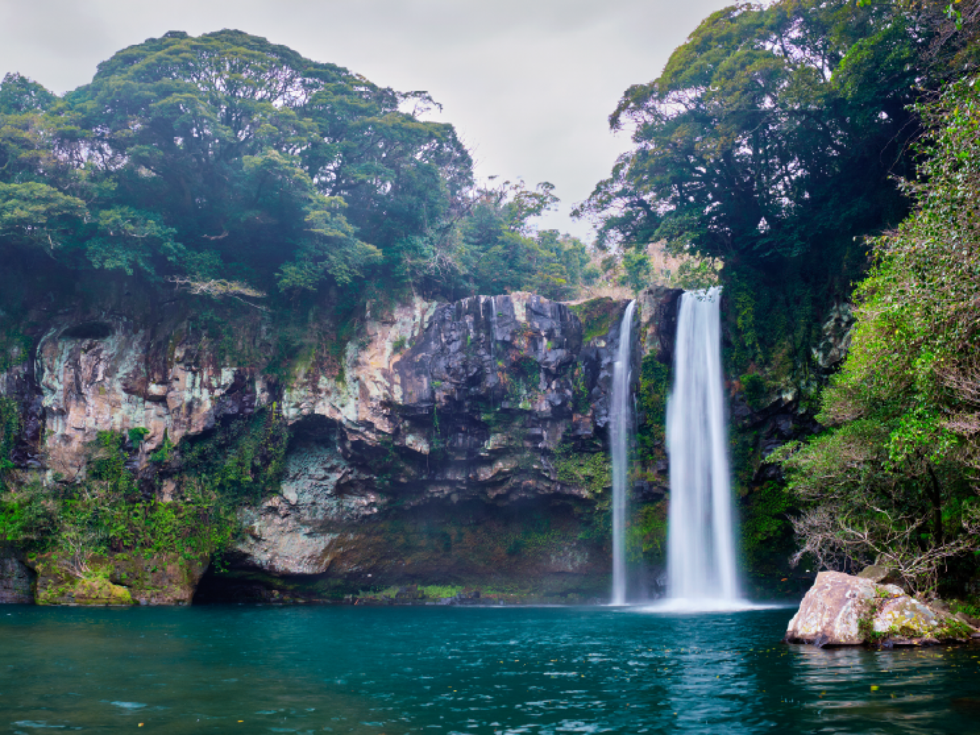 Landscape view of Cheonjiyeon Waterfalls on Jeju Island, South Korea by Dmitry Rukhlenko / AdobeStock