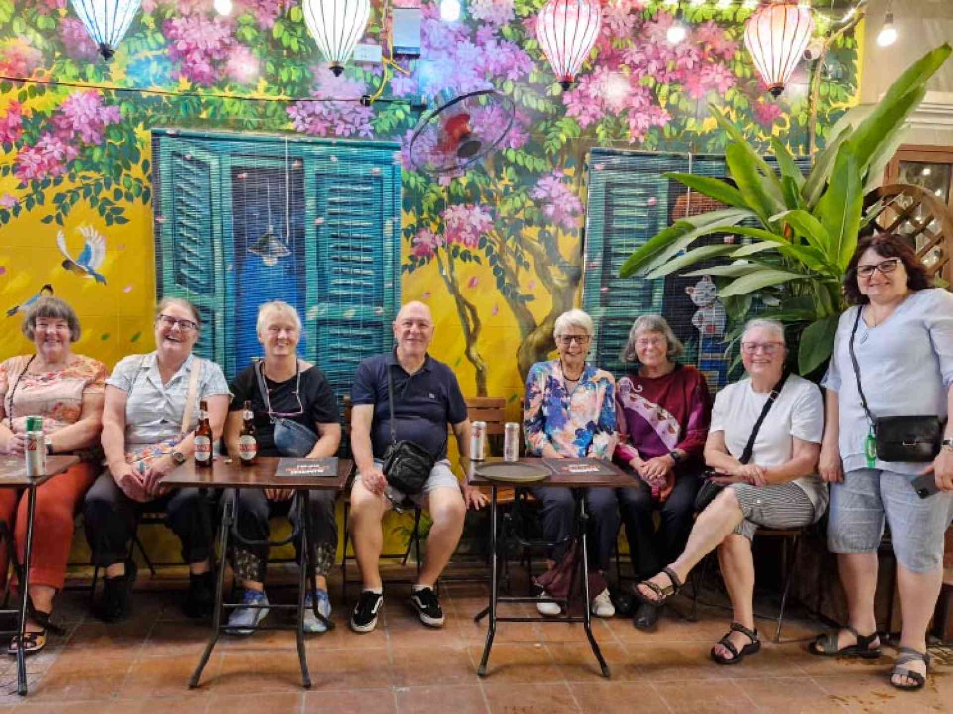 A group of travellers in front of colourful lanterns in Hanoi on a Vietnam tour