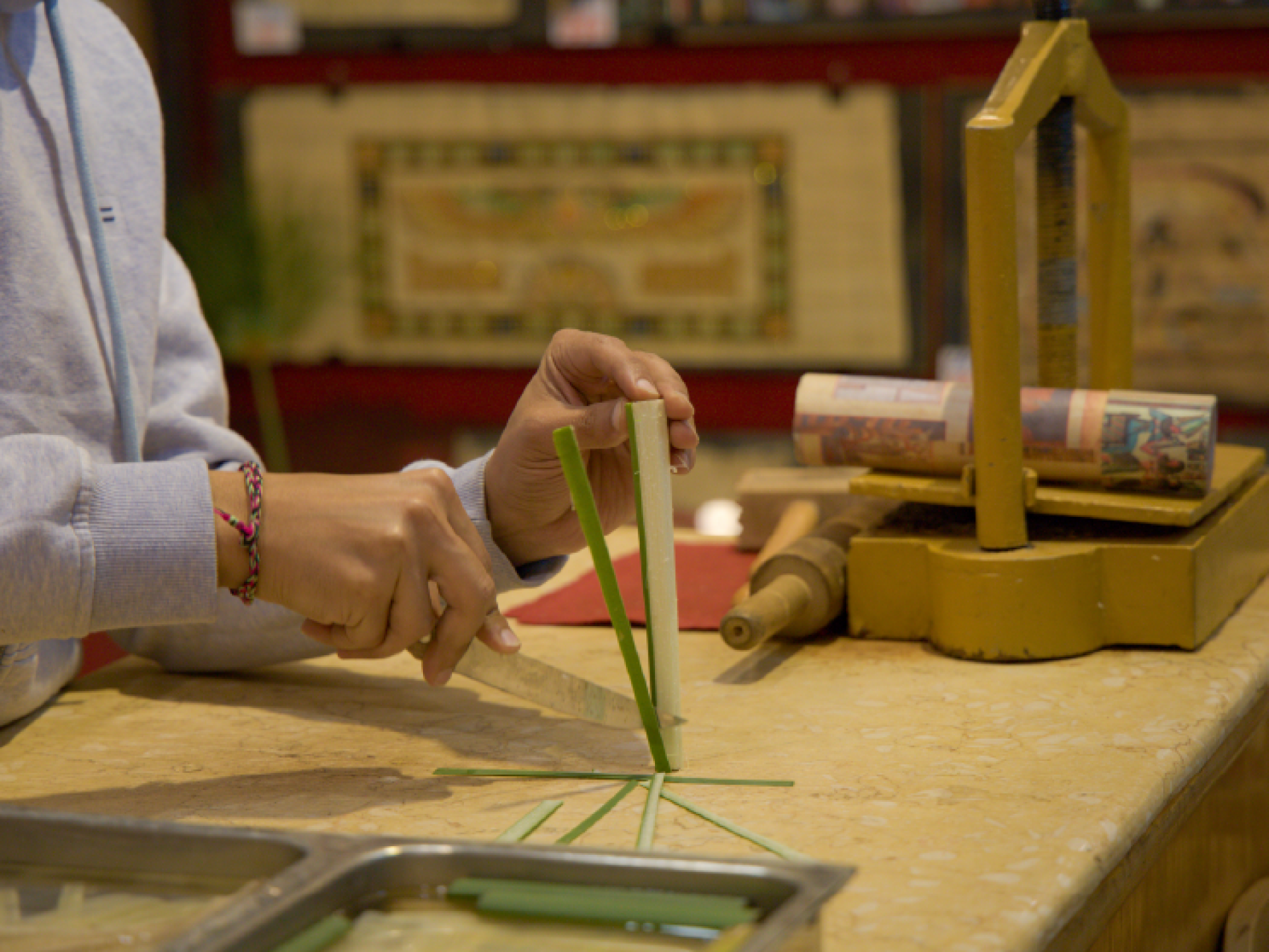 Artist slicing a reed during a papyrus workshop in Egypt