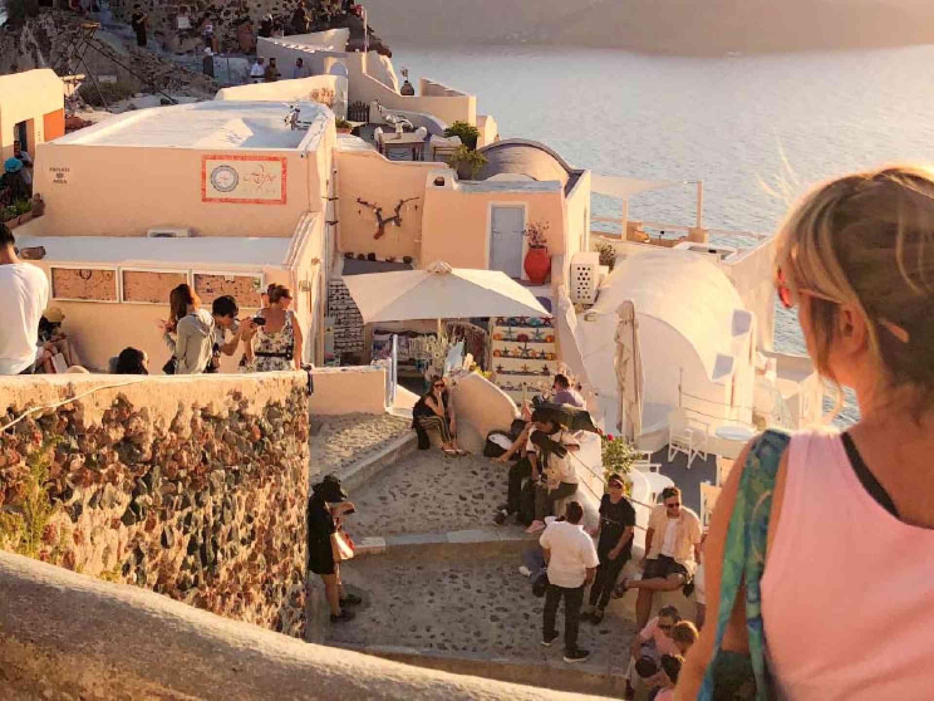 A woman standing in Oia, Santorini in Greece on a Bunnik Tour