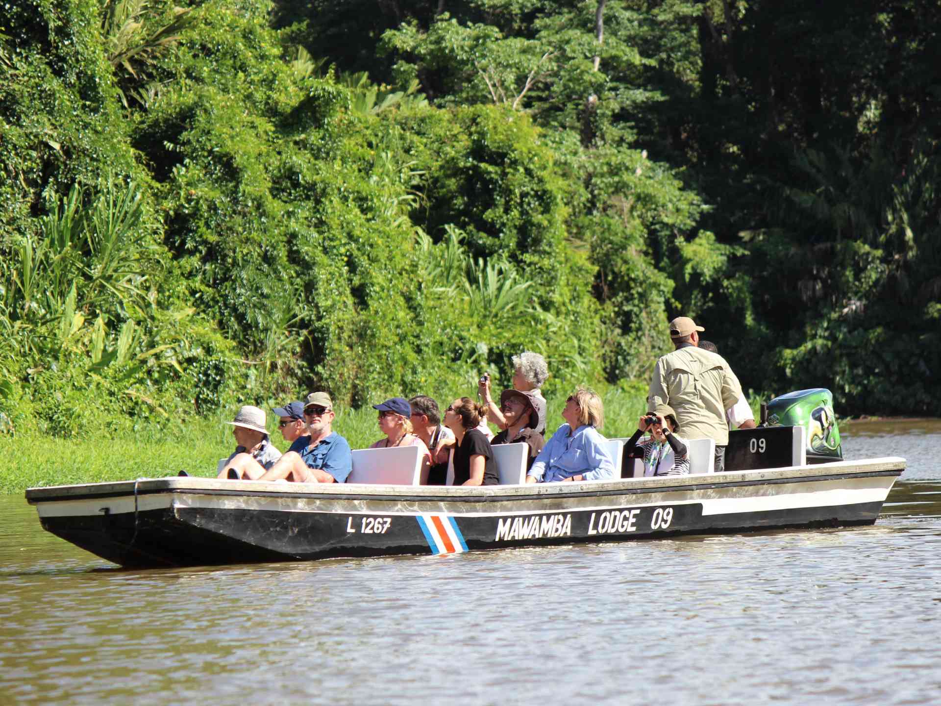 A boat cruising through Tortuguero, Costa Rica by Emily Fraser